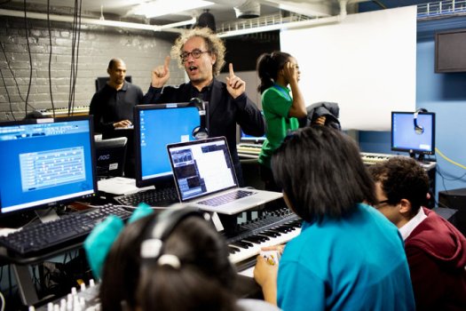 The composer Tod Machover with students at YouthVille in Detroit. They will take part in his “Symphony in D,” a “city symphony” that will have its premiere with the Detroit Symphony Orchestra. Credit Laura McDermott for The New York Times